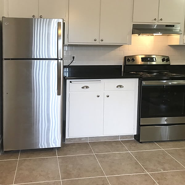 Kitchen with stainless refrigerator
